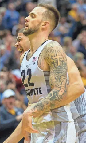  ?? ASSOCIATED PRESS ?? Marquette’s Katin Reinhardt (front) and Haanif Cheatham react Tuesday after Reinhardt made a three-pointer to tie Villanova in the second half of the Golden Eagles’ upset victory.