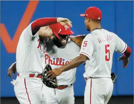  ?? FRANK FRANKLIN II — THE ASSOCIATED PRESS ?? The Phillies’ Rhys Hoskins, left, Odubel Herrera, center and Nick Williams celebrate the team’s 7-3 win against the New York Mets on Tuesday in New York.