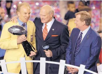  ?? AP FILE ?? Hall of Fame quarterbac­k Roger Staubach, holding the Lombardi Trophy, stands by Steelers great Terry Bradshaw, center, and commission­er Roger Goodell following Super Bowl XLV.