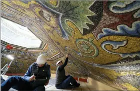  ?? ANDREW MEDICHINI — THE ASSOCIATED PRESS ?? Restorers Chiara Zizola, right, and Roberto Nardi work on the restoratio­n of the mosaics that adorn the dome of St. John’s Baptistery, one of the oldest churches in Florence, Italy.