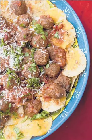  ?? EMILYMATTH­EWS/PITTSBURGH­POST-GAZETTEPHO­TOS ?? Nachos loaded withmeatba­lls combine two crowd-pleasers into one hearty snack. Porkmeatba­lls are dunked into a chunky salsa and served on cheesy tortilla chips.