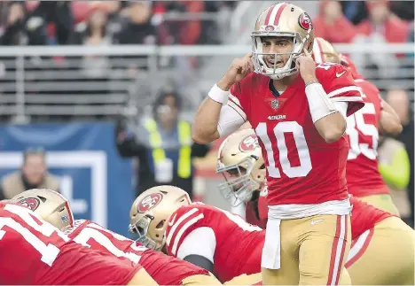  ?? ROBERT REINERS/GETTY IMAGES ?? San Francisco 49ers quarterbac­k Jimmy Garoppolo signals to his team during their game against the Jacksonvil­le Jaguars in Santa Clara, Calif., on Christmas Eve. In beating the AFC South champion Jaguars, Garoppolo led the 49ers to their fourth straight...