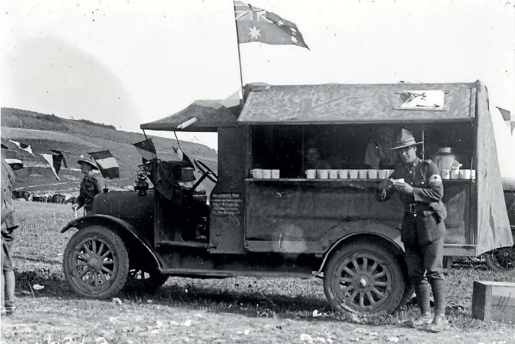  ?? HENRY ARMYTAGE SANDERS. ?? A lorry nicknamed a ‘‘Buckshee Mac’’ provides a canteen service to soldiers at the Anzac Horse Show, France, during World War I. A row of mugs is visible on a shelf along one side of the vehicle.