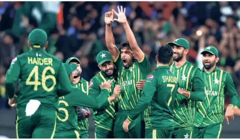  ?? AP ?? Adrenaline rush: Haris Rauf (centre) reacts after getting rid of Suryakumar Yadav. At 26 for three in the sixth over, India had its back to the wall.