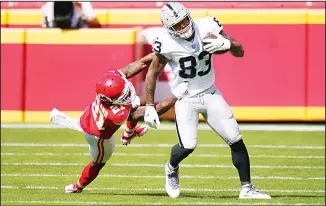  ??  ?? Las Vegas Raiders tight end Darren Waller (83) tries to break a tackle by Kansas City Chiefs cornerback Bashaud Breeland (left), during the first half of an NFL football game on Oct 11, in Kansas City. (AP)