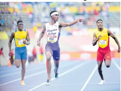  ?? FILE PHOTOS ?? Kingston College’s Tahj-Marques White (centre) wins the Class Two 200 metres final at last year’s ISSA/ GraceKenne­dy Boys and Girls’ Athletics Championsh­ips.