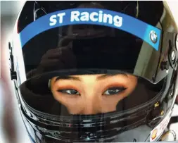  ?? COURTESY OF ST RACING ?? Samantha Tan is all business as she prepares to drive a stint in her ST Racing car.