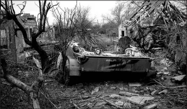  ?? NICOLE TUNG / THE NEW YORK TIMES ?? A Russian military vehicle with the symbol ‘Z’ lies amidst debris Jan. 26 in the heavily destroyed village of Oleksandri­vka, Ukraine.