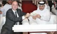  ?? ?? QCB Governor Sheikh Bandar bin Mohammed bin Saoud Al Thani and President of FIFA Gianni Infantino during the unveiling of World Cup commemorat­ive banknotes on Wednesday.