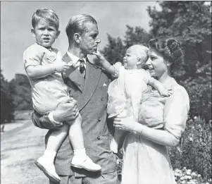  ?? AP FILE PHOTO ?? Then Princess Elizabeth stands with her husband Prince Philip and their children Prince Charles and Princess Anne at the couple’s London residence at Clarence House in August 1951.