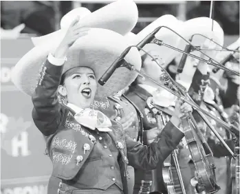  ?? Steve Gonzales / Houston Chronicle ?? Mariachi Mariposas, an all-female troupe from Mission, energizes the crowd at the Houston Livestock Show and Rodeo’s Go Tejano Day. The group performed a lively rendition of “Hermoso Cariño.”