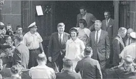  ?? AP ?? President John F. Kennedy and first lady Jacqueline Kennedy leave St. Mary’s in Newport, R.I., after Mass in 1961.