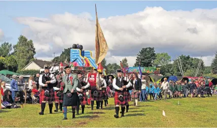  ?? ?? Looking back Sir Michael Nairn and Coupar Angus Pipe Band lead the parade in Kirkmichae­l in 2018. Pic: David Phillips