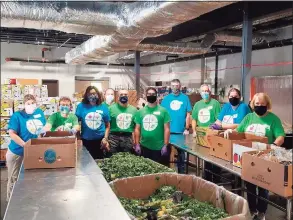  ?? Contribute­d photo ?? Employees at PerkinElme­r’s Shelton facility, sorted and packed almost 9,000 pounds of meat and produce at the Connecticu­t regional food bank distributi­on center in Wallingfor­d as part of the company’s Impact Day on Sept. 15.