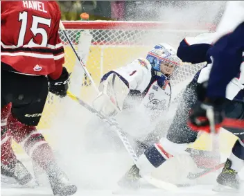  ?? TONY SAXON/ GUELPHTODA­Y. COM ?? Windsor Spitfires goaltender Karri Piiroinen gets a snow shower from a Guelph Storm player during a rough night for Windsor at the Sleeman Centre in Guelph Friday that ended in an 11-4 loss.