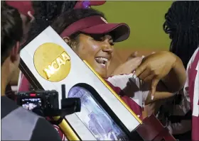  ?? AP PHOTO/SUE OGROCKI ?? Oklahoma’s Jocelyn Alo holds the trophy after Oklahoma defeated Texas in the NCAA softball Women’s College World Series finals Thursday, June 9, 2022, in Oklahoma City.