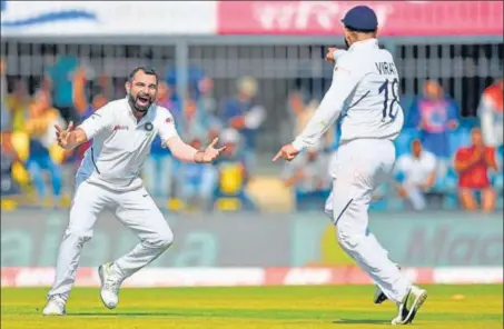  ??  ?? Mohammed Shami (left) celebrates with India captain Virat Kohli after dismissing Bangladesh's Mushfiqur Rahim on the first day of the first Test, in Indore on Thursday.