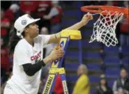  ?? AP PHOTO/JAMES CRISP ?? Louisville’s Asia Durr, Regional MVP, reaches for the net after an NCAA women’s college basketball tournament regional final against Oregon State, Sunday in Lexington, Ky. Louisville won 76-43.