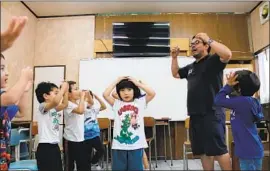  ?? Joseph Coleman For The Times ?? RAFAEL KINOSHITA, who endured a difficult childhood as the son of foreign workers, now teaches music to young Brazilians in Japan from migrant enclaves.
