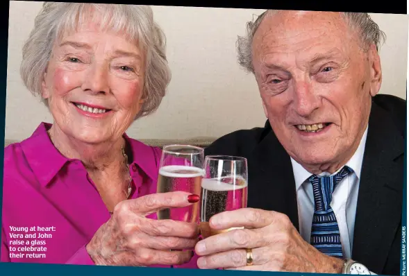  ??  ?? Young at heart: Vera and John raise a glass to celebrate their return