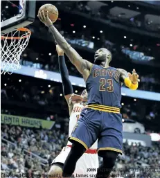  ?? JOHN BAZEMORE /ASSOCIATED PRESS FILES ?? Cleveland Cavaliers forward LeBron James scores against Atlanta Hawks centre Al Horford during the second half of a regular season game between the second round combatants. Game 1 of the Eastern Conference semifinal series between the Hawks and...