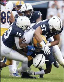  ?? BARRY REEGER — THE ASSOCIATED PRESS ?? Penn State defenders PJ Mustipher (97), Trent Gordon (19), Cam Brown (6) and Lamont Wade (38) tackle Pittsburgh running back A.J. Davis (21).