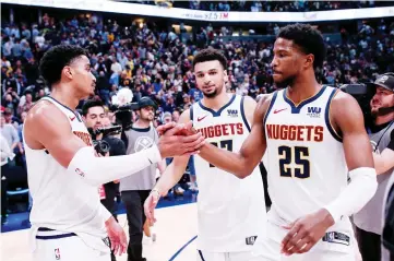  ?? — USA TODAY Sports photo ?? (From left) Denver Nuggets guard Gary Harris, guard Jamal Murray and guard Malik Beasley celebrate after the game against the San Antonio Spurs in game two of the first round of the 2019 NBA Playoffs at the Pepsi Centre.