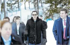  ?? THE ASSOCIATED PRESS ?? Steven Mnuchin, United States Secretary of the Treasury, walks through the snow Wednesday during the annual meeting of the World Economic Forum in Davos, Switzerlan­d.