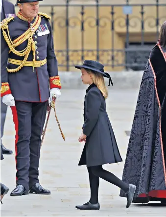  ?? ?? Fit for a princess Princess Charlotte,above, wore a pleated coat dress by Ancar, and a sweet boater-style hat by Jane Taylor