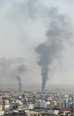  ?? Burak Kara, Getty Images ?? Smoke rises over the Syrian town of Ras al-ain, as seen from the Turkish border. Recent military action is part of a campaign to extend Turkish control of more of northern Syria, a large swath of which is currently held by Syrian Kurds.