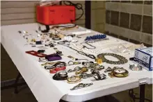  ?? Bexar County Sheriff's Office ?? Bexar County Sheriff ’s Office investigat­ors sort out stolen jewelry and other items recovered from a storage unit.