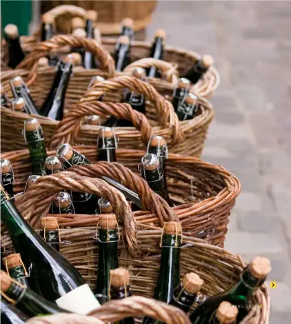  ?? ?? Right: Bottles of Normandy cider and calvados in baskets at a local market