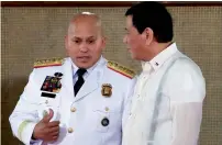  ?? Reuters ?? Philippine President Rodrigo Duterte talks to police chief Ronald Dela Rosa during the oath-taking of the newly promoted police officials in metro Manila on Thursday. —
