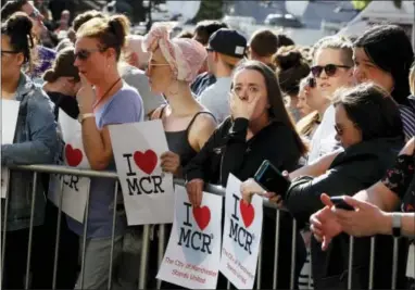  ?? KIRSTY WIGGLESWOR­TH — THE ASSOCIATED PRESS ?? People attend a vigil in Albert Square, Manchester, England, Tuesday the day after the suicide attack at an Ariana Grande concert that left 22 people dead as it ended on Monday night.