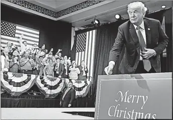  ?? [ANDREW HARNIK/THE ASSOCIATED PRESS] ?? President Donald Trump points to a sign that reads “Merry Christmas” as he arrives Wednesday at a convention center in St. Charles, Mo., to speak about tax cuts. Trump has made saying “Merry Christmas” a priority.