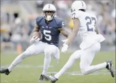  ?? Abby Drey/Associated Press ?? Penn State wide receiver DaeSean Hamilton runs around cornerback T.J. Johnson in the spring Blue-White game.