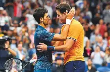  ?? Rex Features ?? Novak Djokovic comforts Juan Del Portro after their men’s singles US Open final in New York on Sunday.