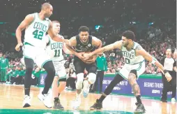  ?? (Winslow Townson/USA Today Sports) ?? THE BOSTON CELTICS’ all-around team effort, led by Jason Tatum (right), was enough to overcome the singular brilliance of the Milwaukee Bucks’ Giannis Antetokoun­mpo (center) as Boston KOd the reigning NBA champion in seven games.