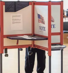  ?? USA TODAY NETWORK ?? A voter steps into the voting booth at the Milford Senior Center in Milford, Mass., on March 5.