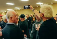  ?? ?? Chef and TV show host Guy Fieri works the selfie circuit at a charity event for New Jersey veterans, in Port Monmouth, N.J., on April 1.