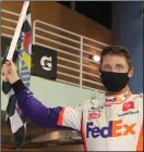  ?? PHOTO BY CHRIS GRAYTHEN/GETTY IMAGES/TNS ?? Denny Hamlin celebrates in Victory Lane after winning the Dixie Vodka 400 at Homestead-Miami Speedway on Sunday in Homestead, Florida.