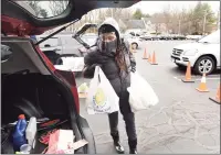  ?? Arnold Gold / Hearst Connecticu­t Media ?? Volunteer Cynthia Credle, of West Haven, loads a car with food in the parking lot of the Kingdom Life Christian Church Cathedral in Milford on Friday. The Kingdom Life Christian Church Cathedral and Cornerston­e Christian Center partnered with the Connecticu­t Food Bank for the mobile food distributi­on.