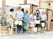  ??  ?? A drop in the bucket: residents collect water from a standpipe in Northam, Devon, during the long hot summer of 1976