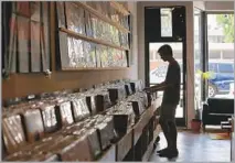 ?? Dania Maxwell Los Angeles Times ?? PARADISE CITY Records & Stuff ’s co-owner says he wants it “to be like nerd heaven.” Customer Jack Seibert seems content.