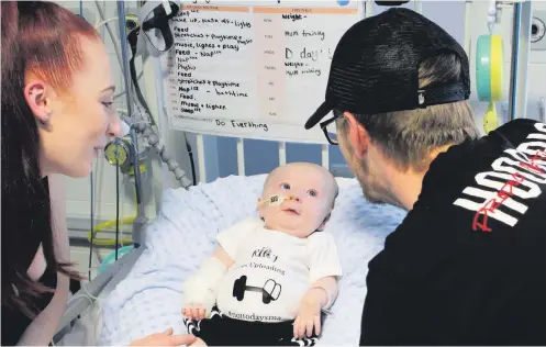  ??  ?? Riley Cadle-Birch, with his mother Jade CadleBilli­ngham and father Ryan Birch, before undergoing treatment at the Bristol Royal Hospital for Children