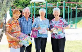  ?? Photo / Rosalie Willis ?? Y’vonne and John Miller with Pauline Donovan and Julie Tregear putting books out at Waikanae Park.