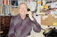  ?? NEWS PHOTO GILLIAN SLADE ?? Levinson Music is cloaked in history. Ken Chisholm, owner, talks on his rotary dial telephone that he refuses to relinquish. Solid wood filing cabinets allow customers to experience another era.
