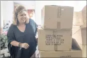  ?? BEN GRAY — THE ASSOCIATED PRESS ?? Ginger Pigg moves boxes of shopping bags in the storage room of her gift boutique The Perfect Pigg in Cumming, Ga. on Thursday afternoon. The bags should have been delivered in four weeks, but took 14 weeks.