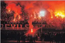  ?? ASSOCIATED PRESS FILE PHOTO ?? In this 2015 photo, hardcore soccer fans known as Ultras Ahlawy, light flares and cheer in Cairo, Egypt, while marking the third anniversar­y of violence in Port Said that claimed 70 lives in 2012.