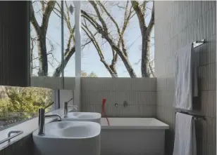 ??  ?? Below, custom-made Japanese Inax tiles and ‘Nivis’ washbasins by Benedini Associati, for Agape, in the en-suite bathroom